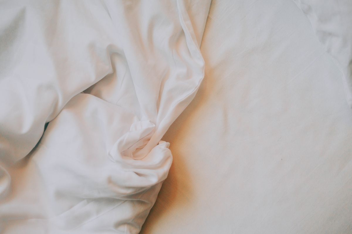 Crisp white duvet folded on a bed