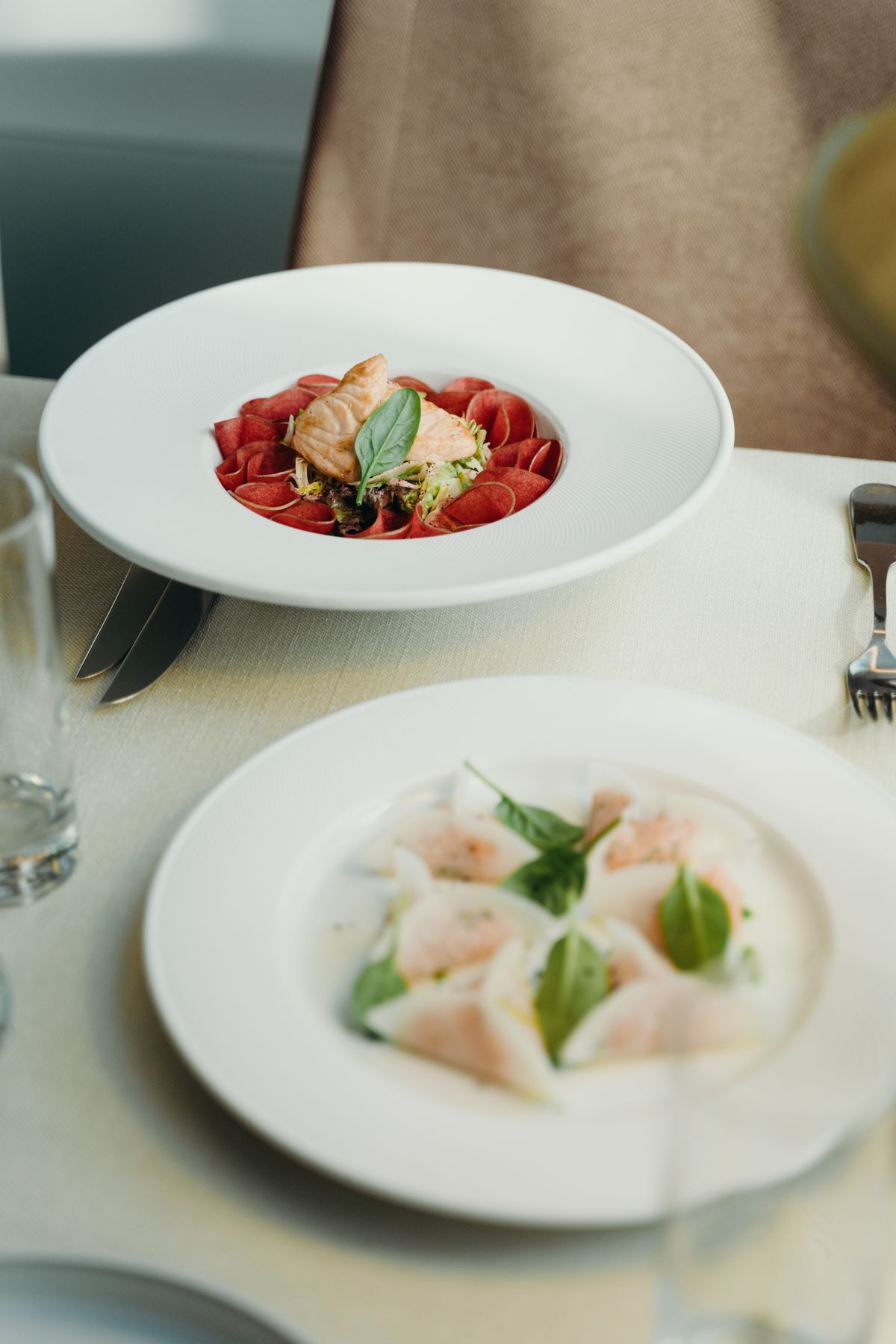 Plated dishes served on a white tablecloth